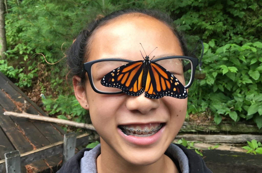 Girl with butterfly on her glasses