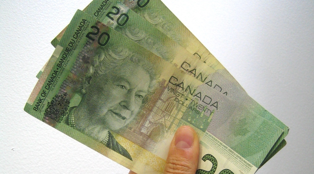 Hand holding Canadian $20s